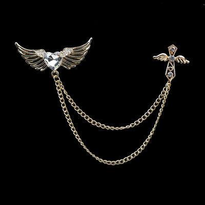 Brooch with angel wings and chain on a black background