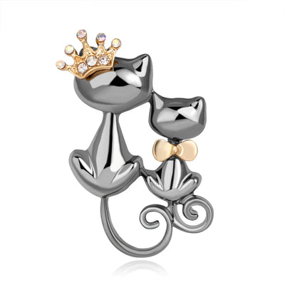 Cat-shaped brooch with a crown and bow tie on a white background