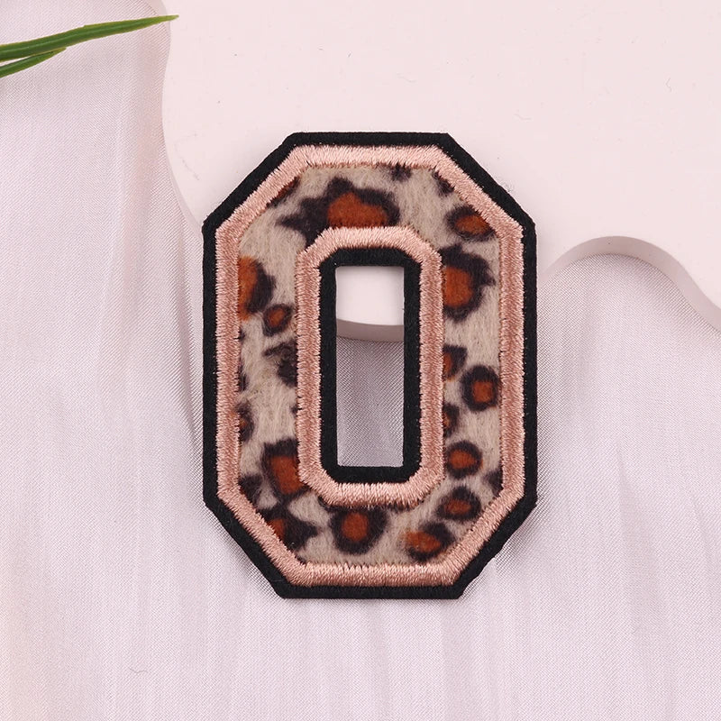 Leopard print number '0' patch on a light pink background