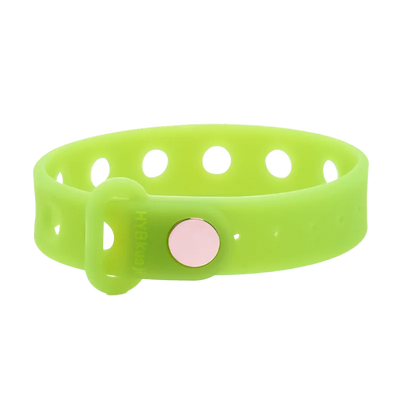 Green wrist band dog collar with a pink button on a white background