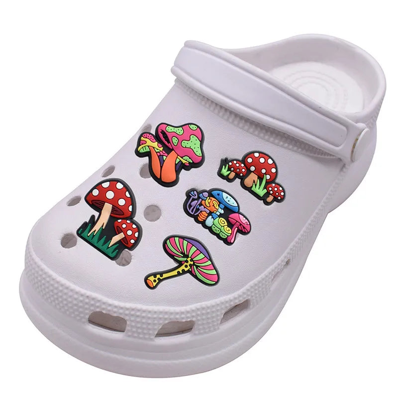 White clog shoe with colorful mushroom shoe pins on a white background