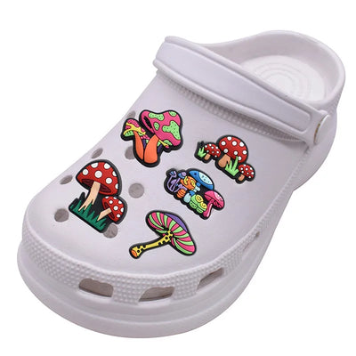 White clog shoe with colorful mushroom shoe pins on a white background