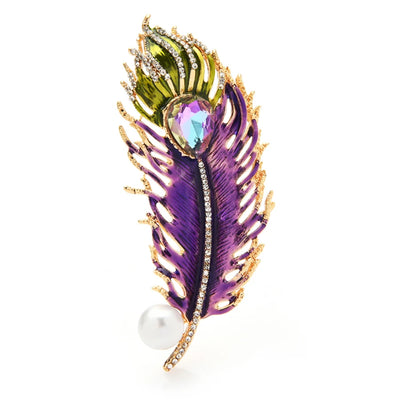 Decorative feather brooch with purple, green, and gold colors on a white background