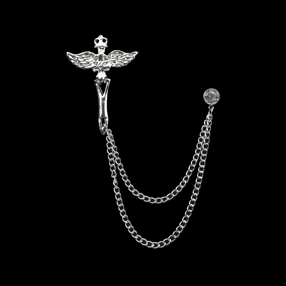 Silver brooch with chain on a black background