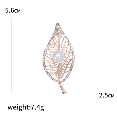 Leaf-shaped brooch with pearl center and rose gold finish, shown with measurements on a white background.