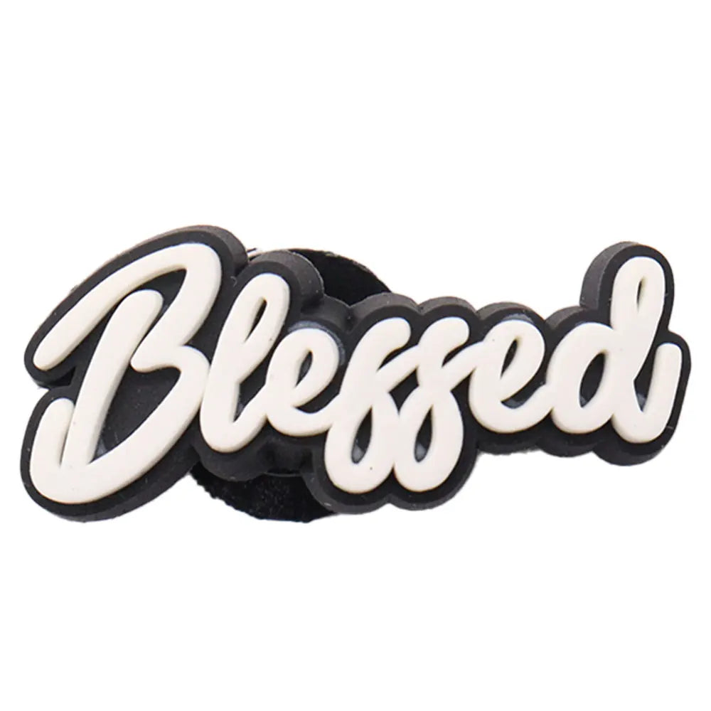 Black and white 'Blessed' charm on a white background