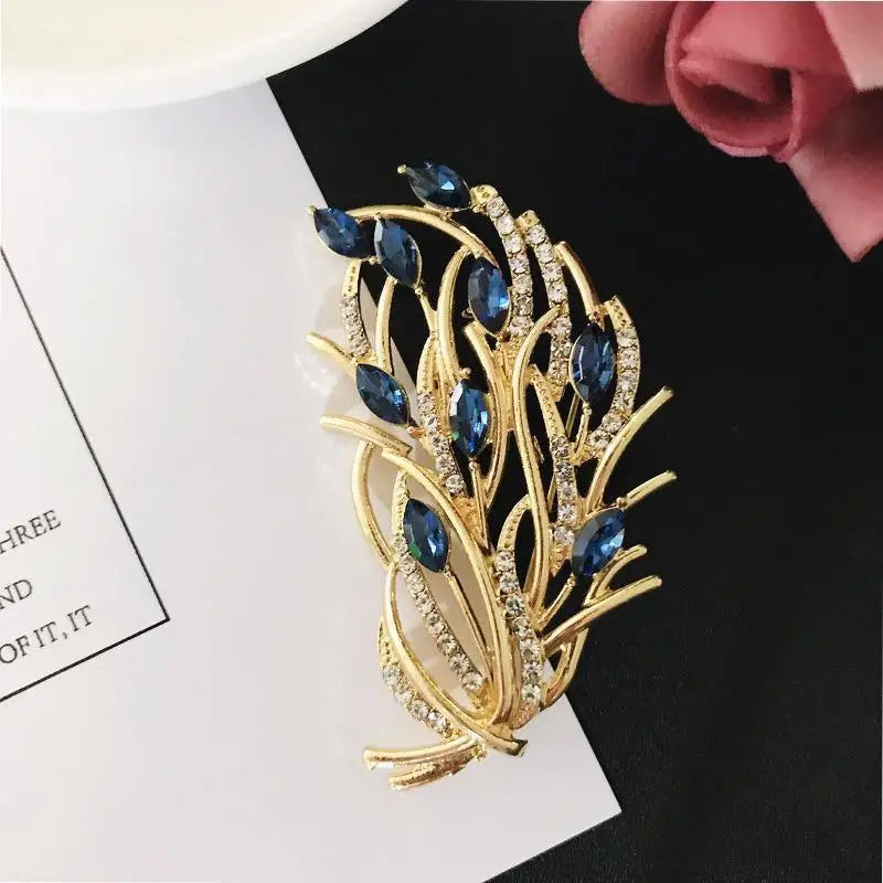 Gold and blue brooch on a black and white background