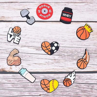 Collection of sports-themed shoe charms on a wooden surface