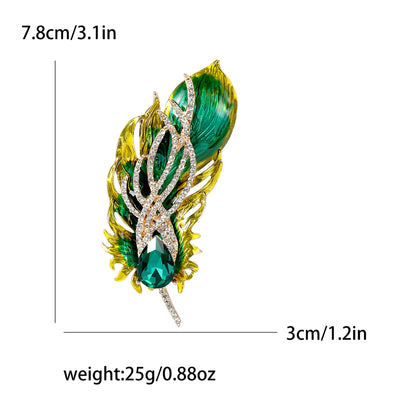 Green and gold feather-shaped brooch with measurements and weight displayed.