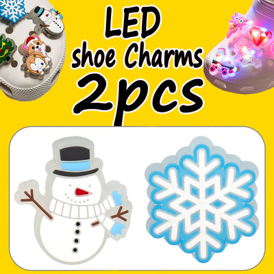 LED shoe charms with snowman and snowflake design on a yellow background