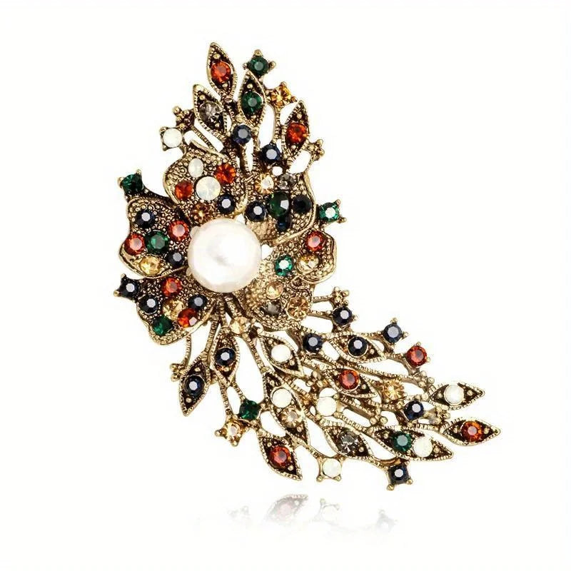 Decorative brooch with pearls and gemstones on a white background