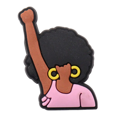 charm of a person with an afro, raised fist, and yellow earrings on a white background