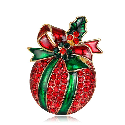 Decorative brooch with red and green design on a white background