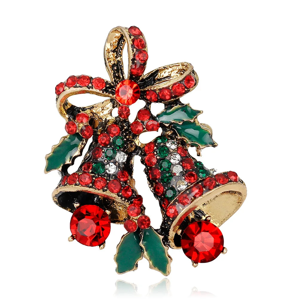 Christmas-themed brooch with red and green gemstones on a white background
