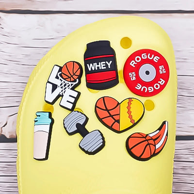 Yellow clog with colorful decorative shoe charms on a wooden surface 