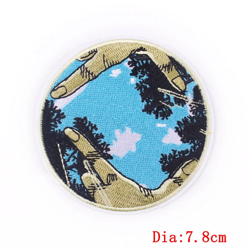 Circular patch with hands holding a landscape design on a white background