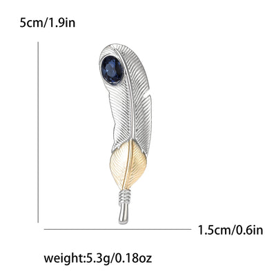 Feather-shaped brooch with blue gemstone and gold accents, shown with measurements and weight on a white background.