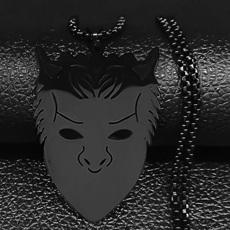 Black mask pendant with chain on a textured black background