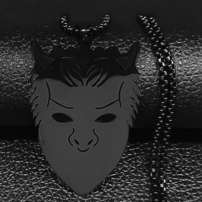 Black mask pendant with chain on a textured black background