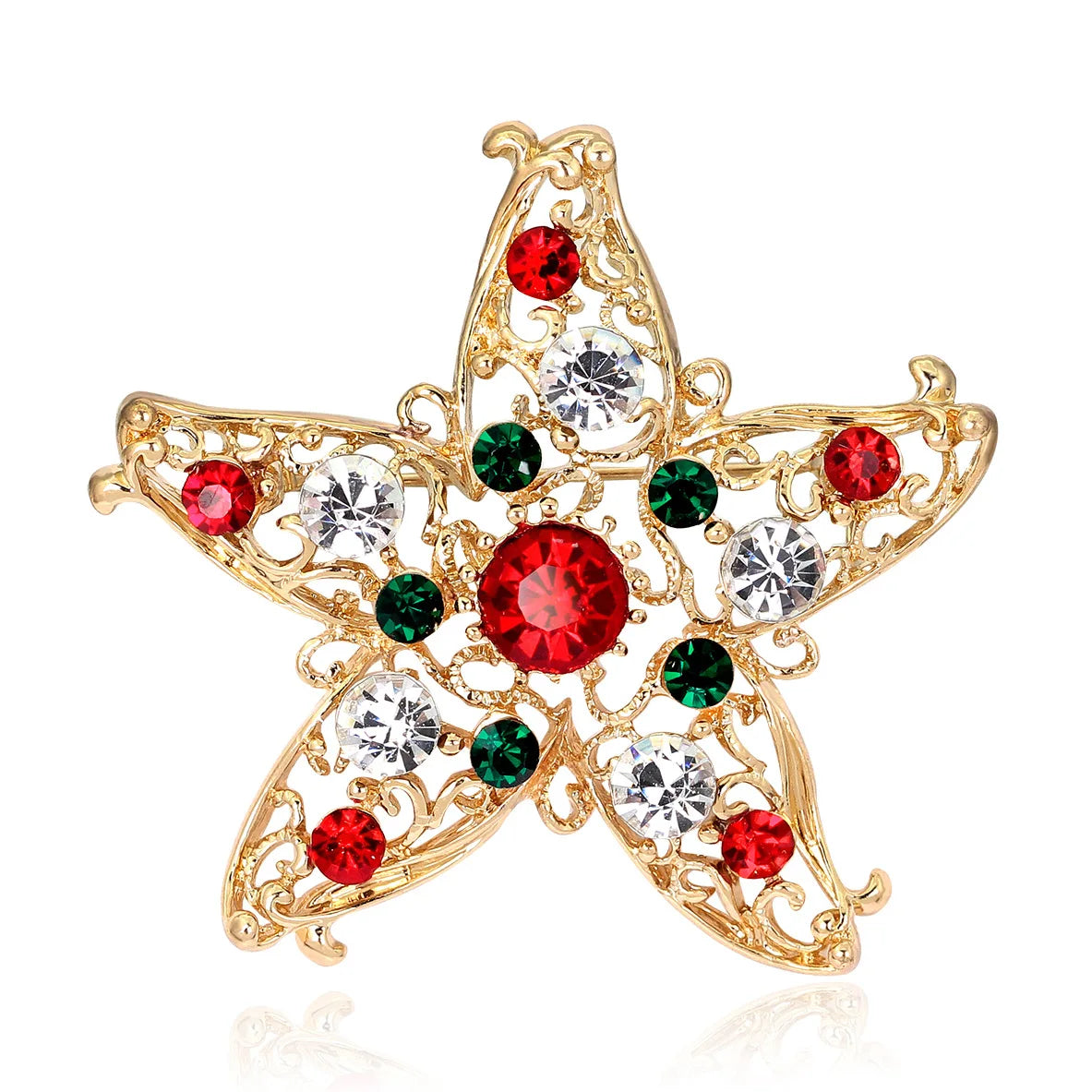 Gold star-shaped brooch with red, green, and clear gemstones on a white background