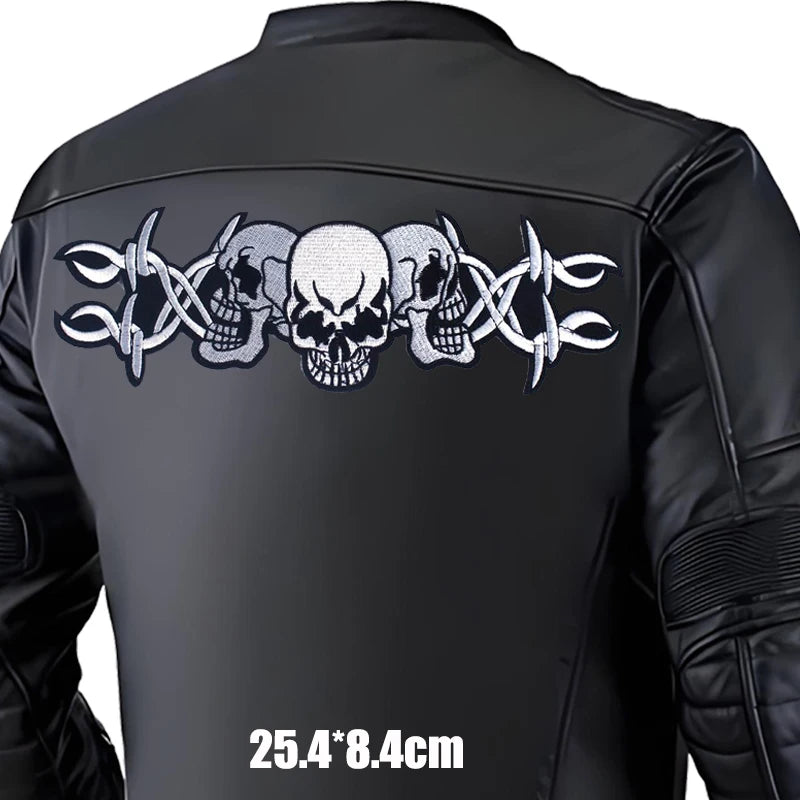 Black leather jacket with skull and crossbar design on the back, size indicated.
