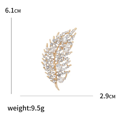 Gold and crystal leaf-shaped brooch with measurements and weight displayed.