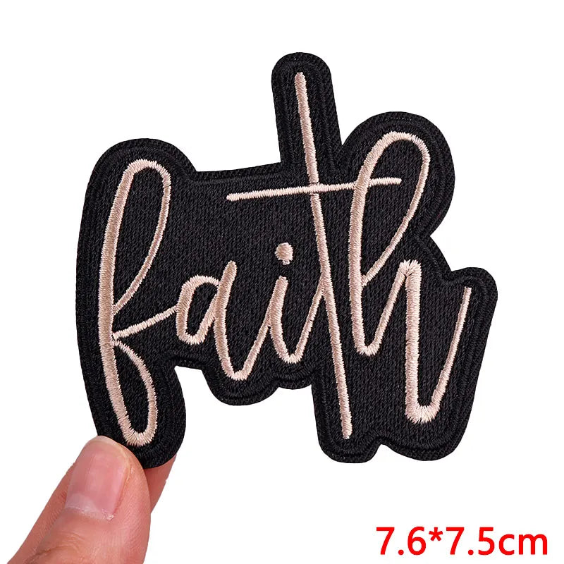 Black patch with 'faith' in cursive held by a hand, size 7.6*7.5cm.