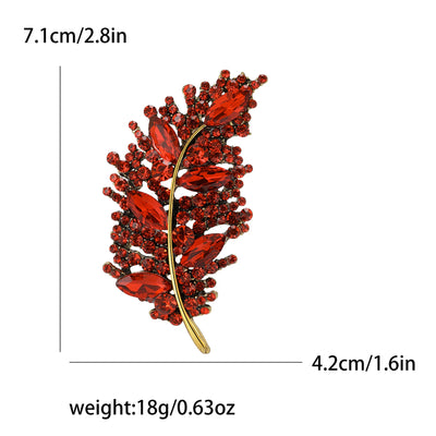 Red leaf-shaped brooch with gold stem, shown with measurements on a white background
