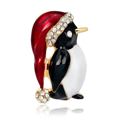 Decorative penguin figurine with red hat and gold accents on a white background