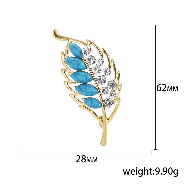 Jewelry brooch with blue stones and gold frame, shown with measurements and weight on a white background.