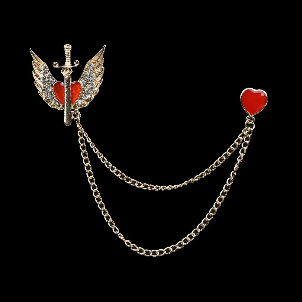 Brooch with sword, wings, and red heart on a chain against a black background