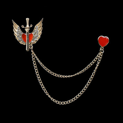 Brooch with sword, wings, and red heart on a chain against a black background