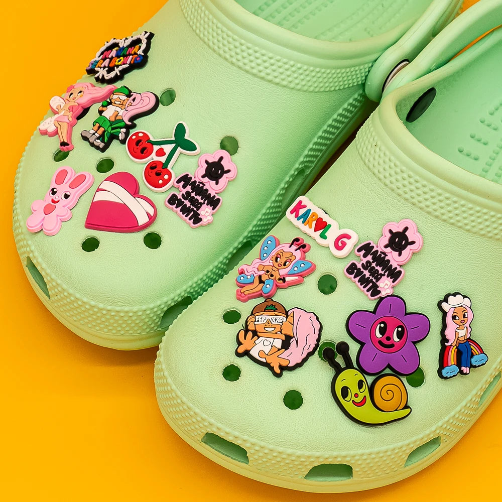 Green clogs with colorful cartoon character charms on a yellow background