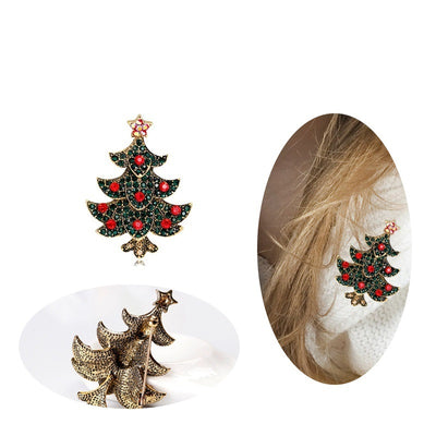 Christmas tree-shaped earrings with red gemstones on a white background.