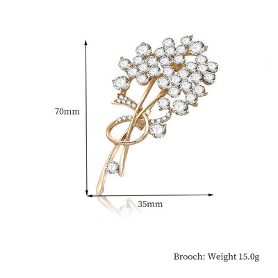 Gold brooch with clear gemstones and measurements on a white background