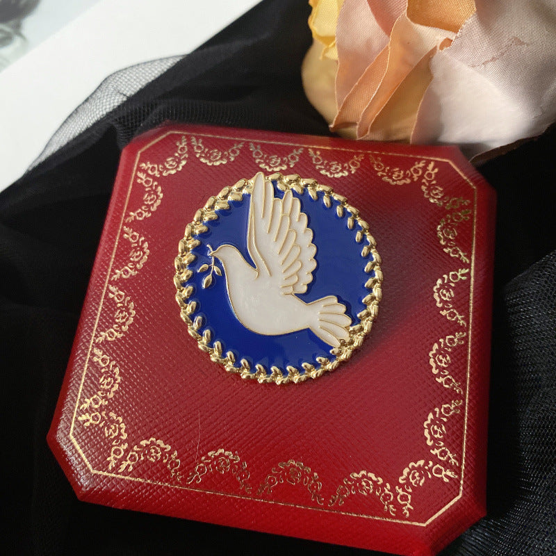 Decorative red box with a dove emblem on a black background