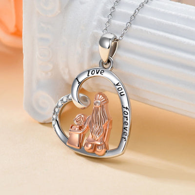 Heart-shaped pendant with two clasped hands and 'I love you forever' engraving on a beige background.