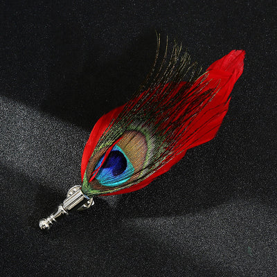 Peacock feather keychain with red accent on a black background