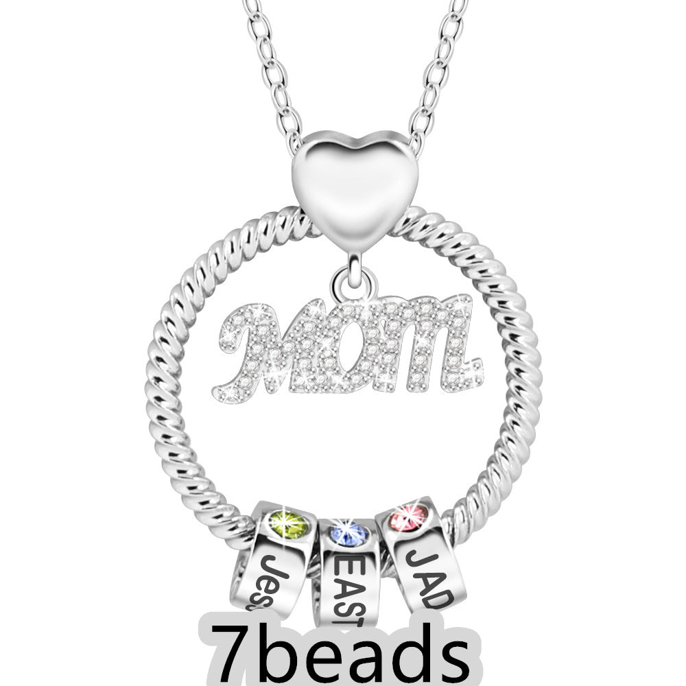 Silver necklace with 'Mom' pendant and three name beads on a white background  7 beads