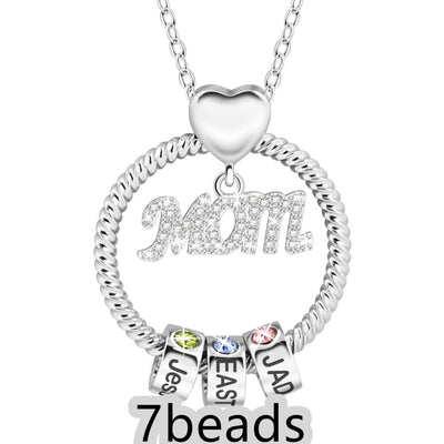 Silver necklace with 'Mom' pendant and three name beads on a white background  7 beads