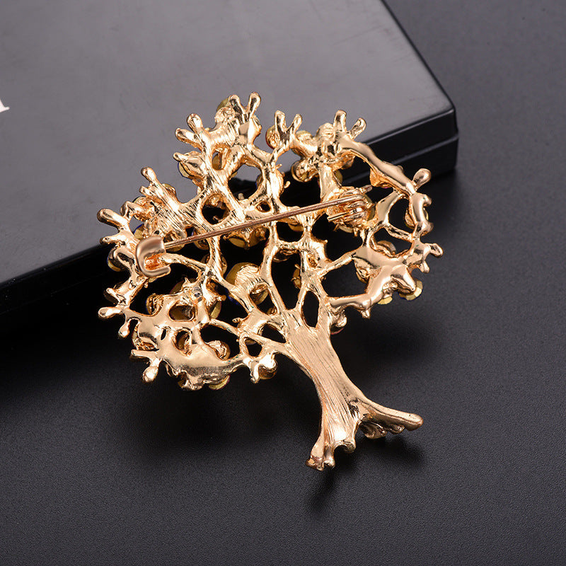 back side of the Gold tree-shaped brooch on a black background