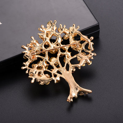 back side of the Gold tree-shaped brooch on a black background