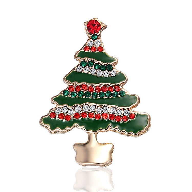 Christmas tree-shaped brooch with green, red, and gold colors on a white background