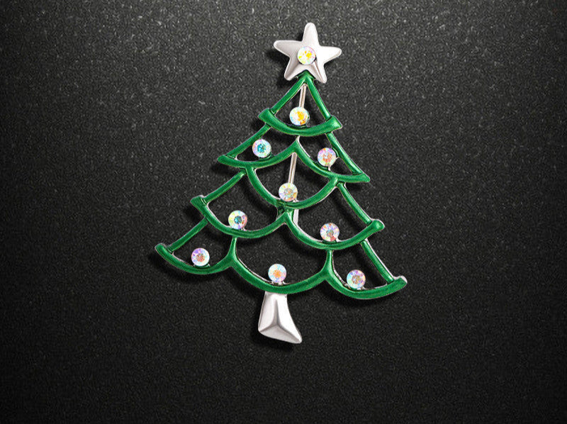 Green Christmas tree-shaped brooch with star on a black background