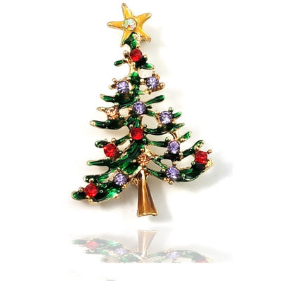 Christmas tree-shaped brooch with colorful gemstones on a white background