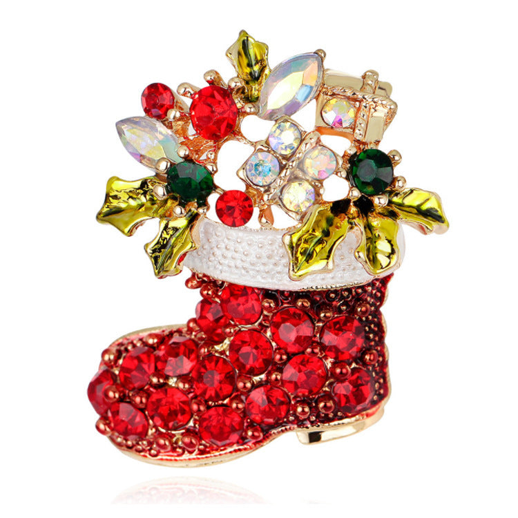 Decorative brooch shaped like a Christmas boot with colorful gemstones on a white background