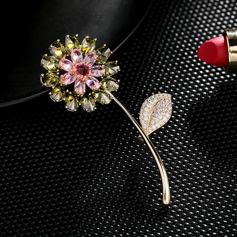 Decorative brooch with floral design on a textured black surface