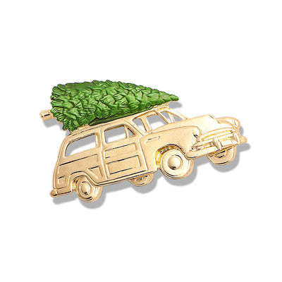Gold car-shaped brooch with a green tree on a white background