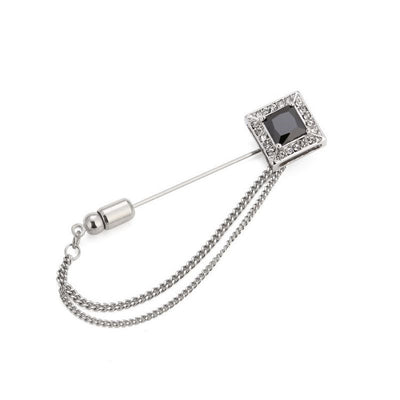 Silver brooch with a chain on a white background