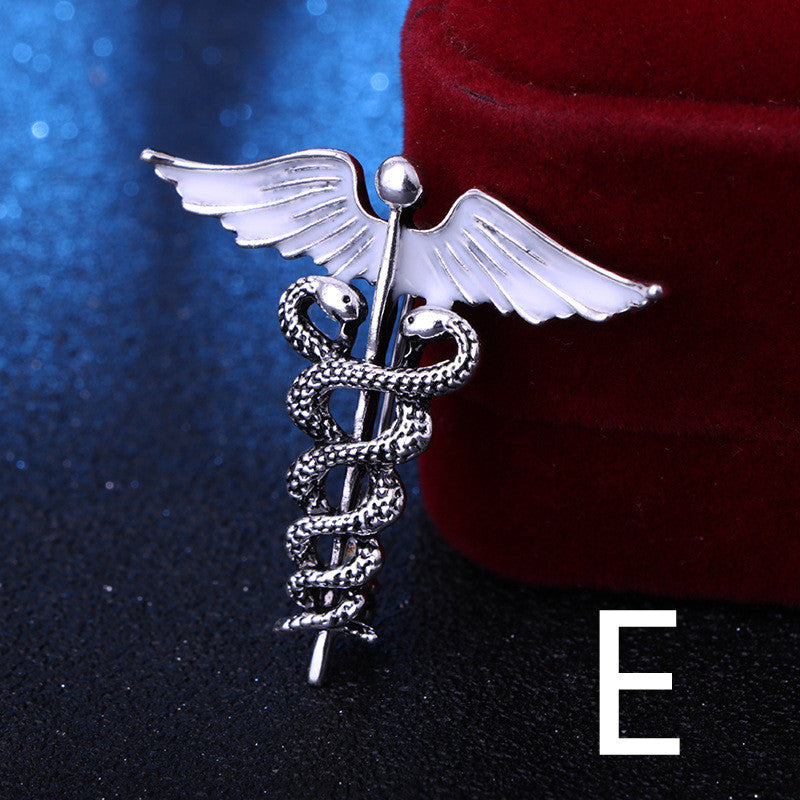 Silver caduceus symbol with wings on a dark background